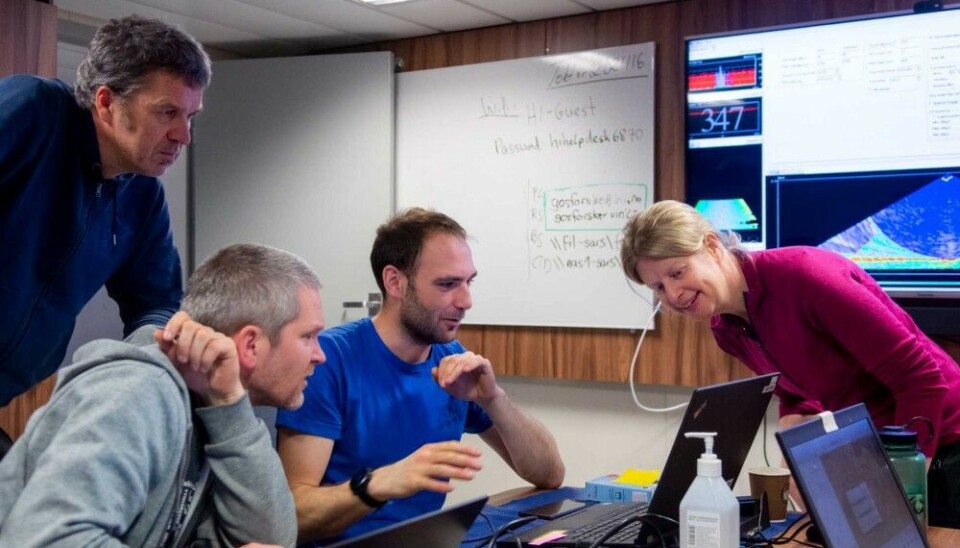 Henry Patton (center) with co-author Monica Winsborrow (right) examining data. Photo: Mauro Pau