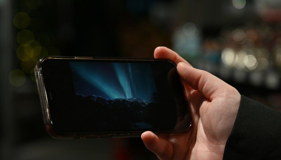 Katrin shows the photo of the Northern lights she saw a few days ago in Norway. Photo: Elizaveta Vereykina