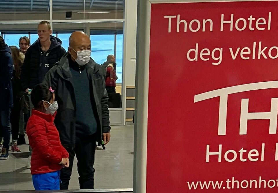 Chinese tourists at the airport in Kirkenes, northern Norway, taking precautions by wearing face masks. Photo: Thomas Nilsen