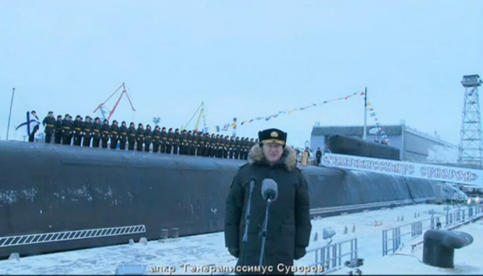Russian navy commander Vice-Admiral Nikolai Yevmenov led the flag-hoisting ceremony for 'Generalissimus Suvorov' as the submarine was handed over to the Pacific Fleet with the crew on deck. Screenshot from the televised ceremony by Kremlin.ru