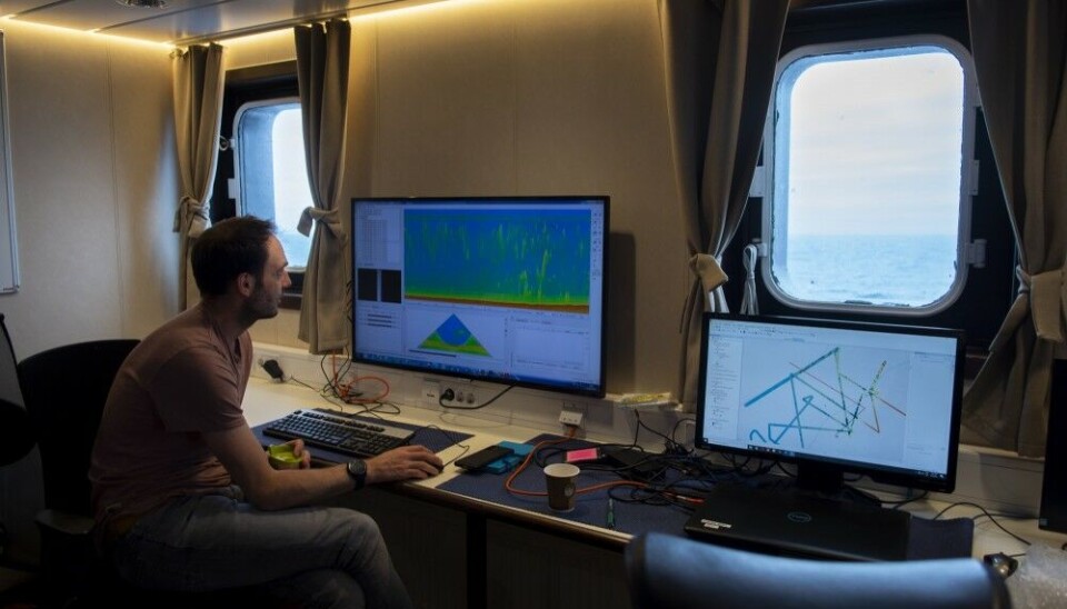 Dr Henry Patton examining newly collected multibeam echosounder data in the instrument room onboard Helmer Hanssen. Photo by Mauro Pau, 2021.