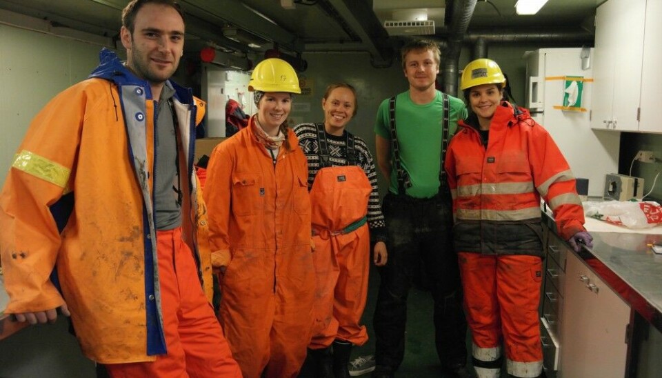 Scientists Calvin Shackleton and Henry Patton with other team members in the ‘wet lab’ onboard Helmer Hanssen in 2015, waiting for a sediment core to be retrieved 300 metres below from the Barents Sea floor. When the team works on the ship deck it’s important for them to wear clothes that are visible and warm.