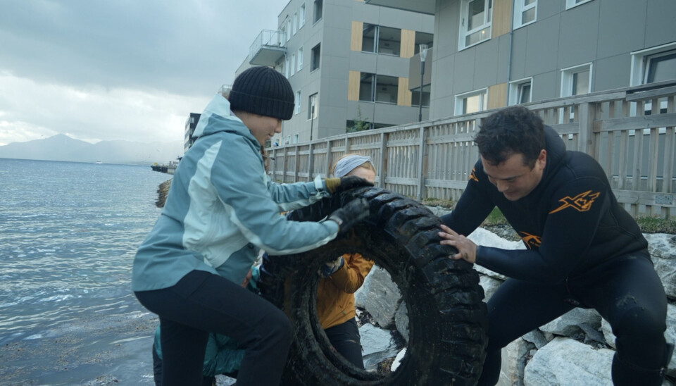 It took four people to lift a truck tyre out from the water. Photo: Elizaveta Vereykina