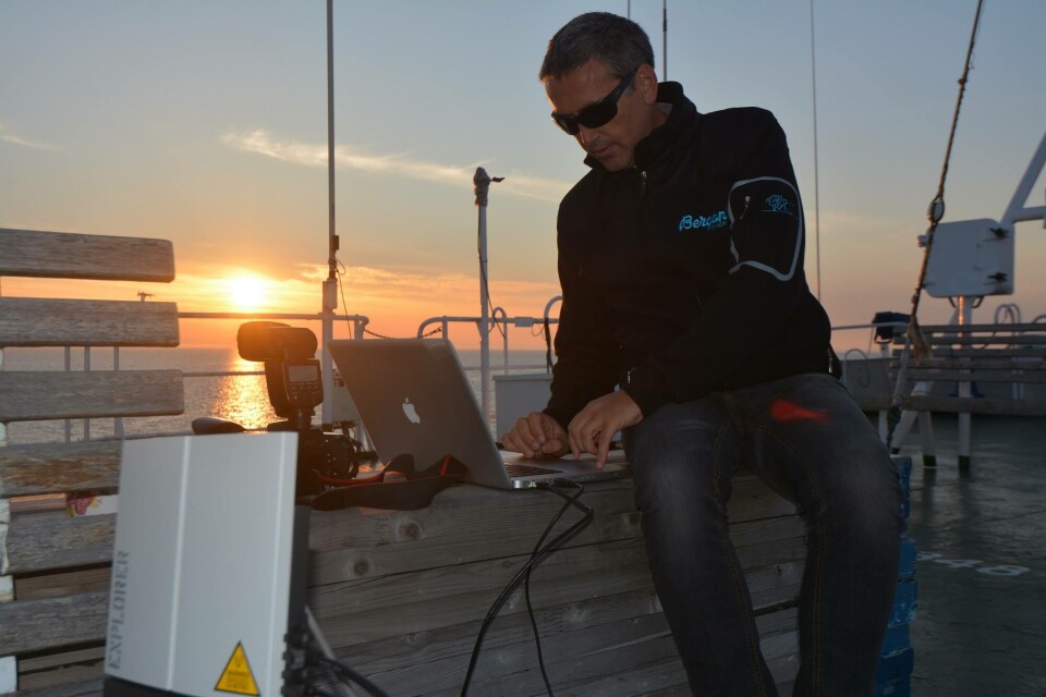 The author while transmitting data via slow-speed satellite connection for the Barents Observer from the deck of an expedition vessel in the Kara Sea some years ago. Photo: Rune Sunnset Alexandersen