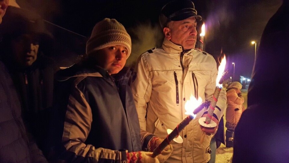 This man and boy at the Western Camp outside Kirkenes agreed to have their photos published. They watched the support demonstration outside the camp taking place last Tuesday. Photo: Thomas Nilsen