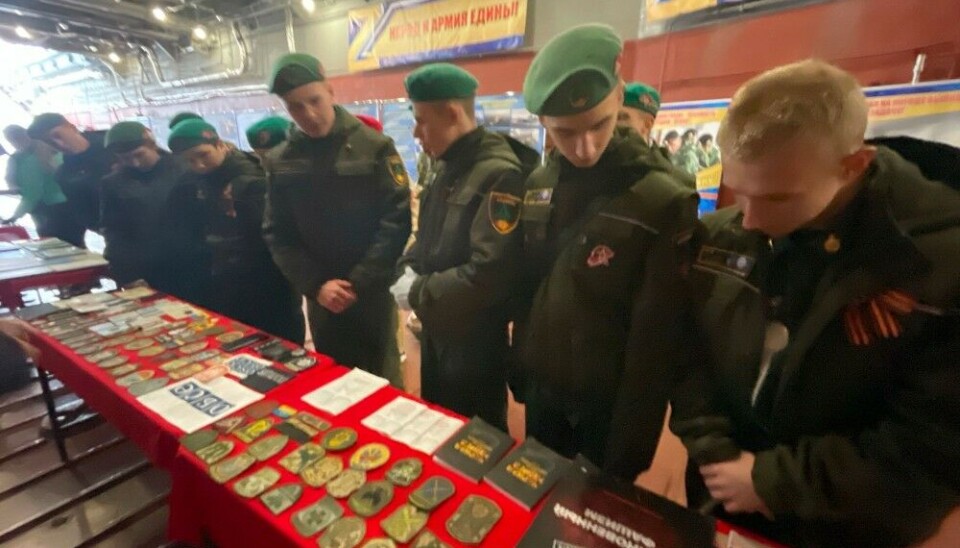 A small flag from the OSCE lies next to military badges from Poland and Ukraine as part of Northern Fleet's propaganda show onboard the Ivan Gren. Photo: yunarmy51 on VK