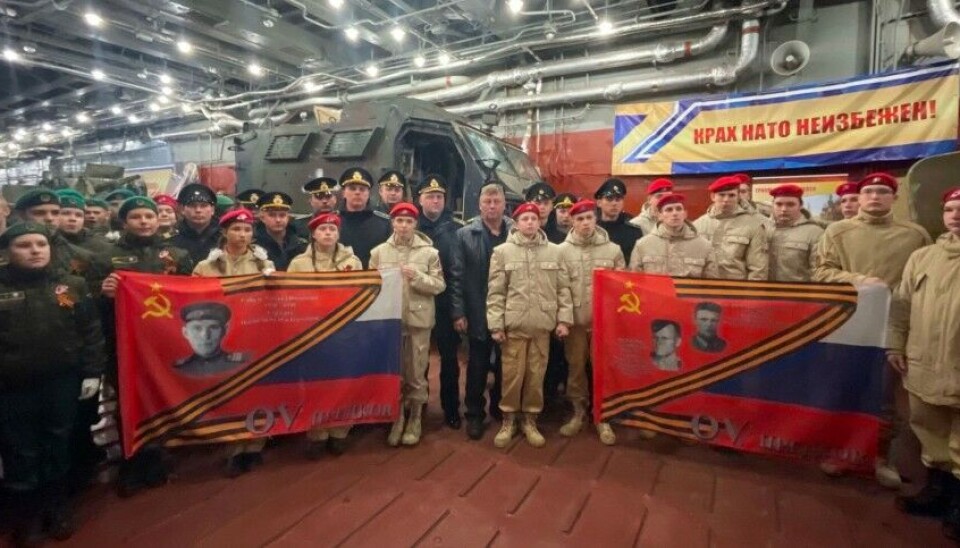 Representatives of the Youth Army in Murmansk hold flags with photos of 2WW heroes in front of Ukrainian military hardware captured in Ukraine and a banner that reads “The collapse of NATO is inevitable.” Photo: yunarmy51 on VK