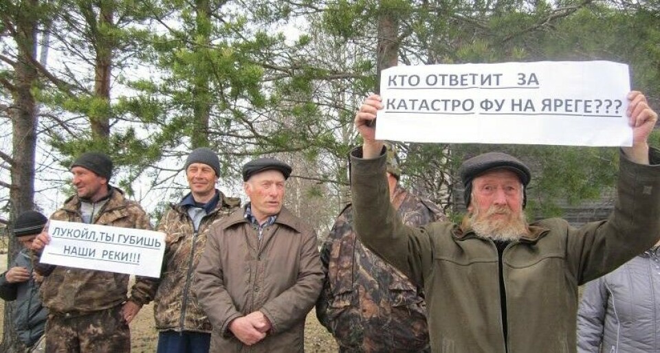Locals rally against oil pollution. 'Lukoil, don't destroy our river' reads the sign to the left. Photo: Committee Save the Pechora