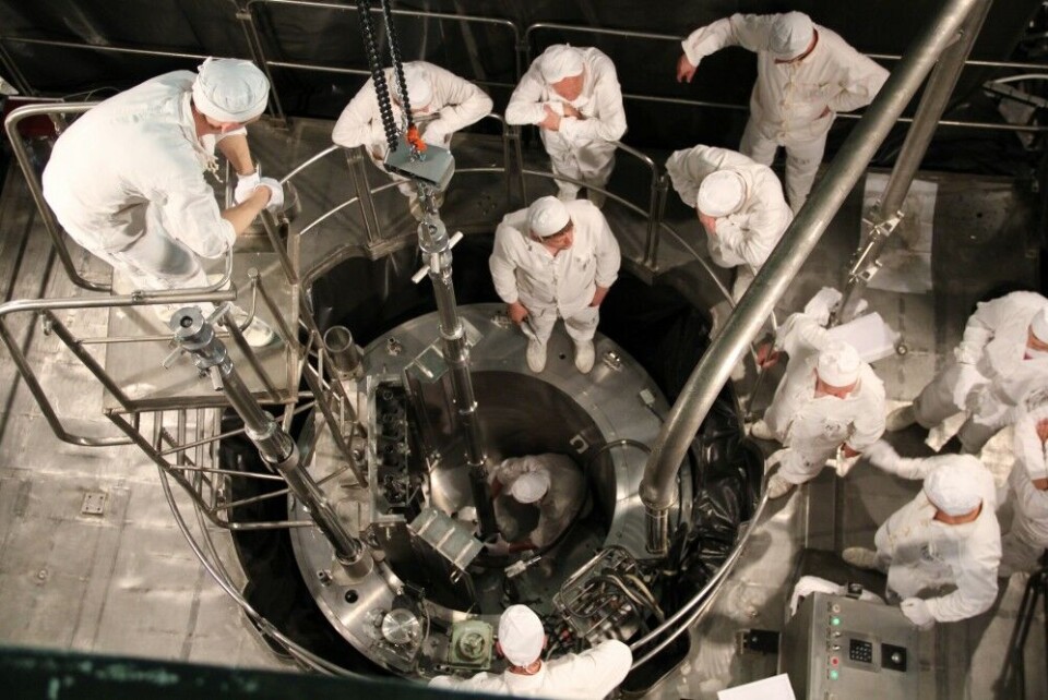 Nuclear engineers overlooking the first uranium fuel roads to be loaded into the reactor. Photo: Rosatom
