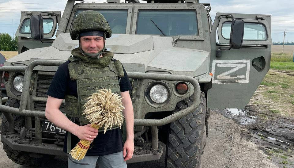 Andrei Chibis poses with stolen Ukrainian grain. Photo from Chibis Telegram channel