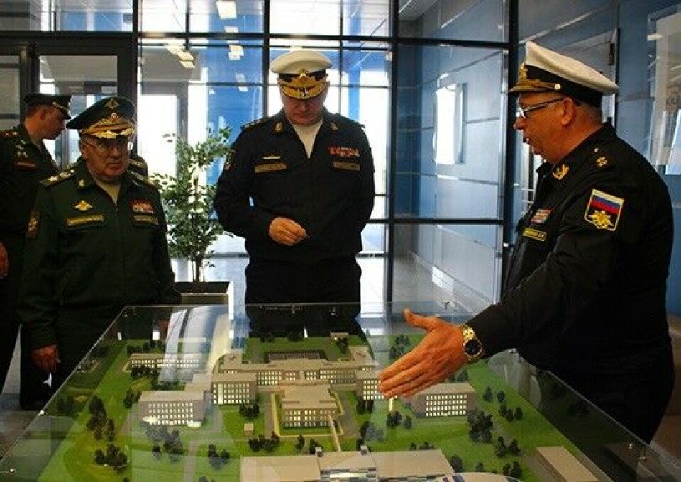 Northern Fleet Head Commander Nikolay Yevmenov takes a look at a plan for Sputnik
