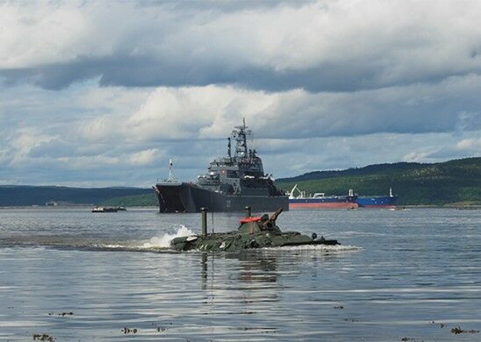 A BTR-80 amphibious armoured personnel carrier drives ashore from the 'Kondapoga' with two oil tankers behind. Photo: Russia's Ministry of Defence