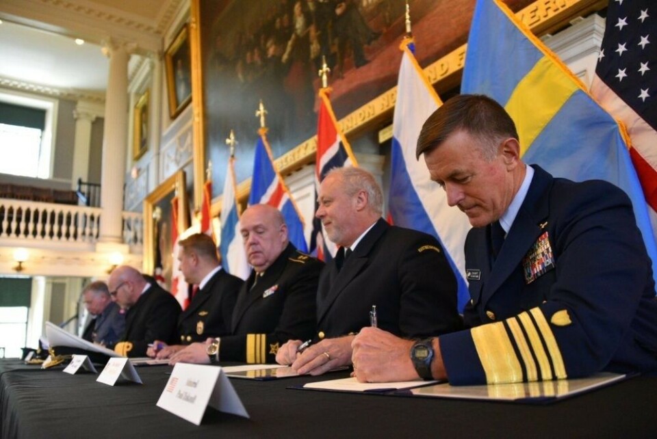 U.S. Coast Guard Commandant Adm. Paul Zukunft (right) and the heads of seven other Arctic nations’ coast guards sign a joint statement in Faneuil Hall in Boston, June 10, 2016. Photo: Petty Officer 2nd Class Patrick Kelley/U.S. Coast Guard