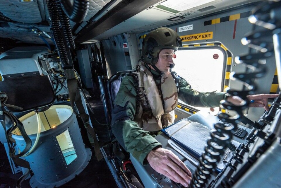 A Dutch Navy acoustic operator listens and manages the signal received by the sonar aboard an NH-90 helicopter while tracking a submarine during Exercise Dynamic Mongoose. NATO Photo by FRA N WO Christian Valverde