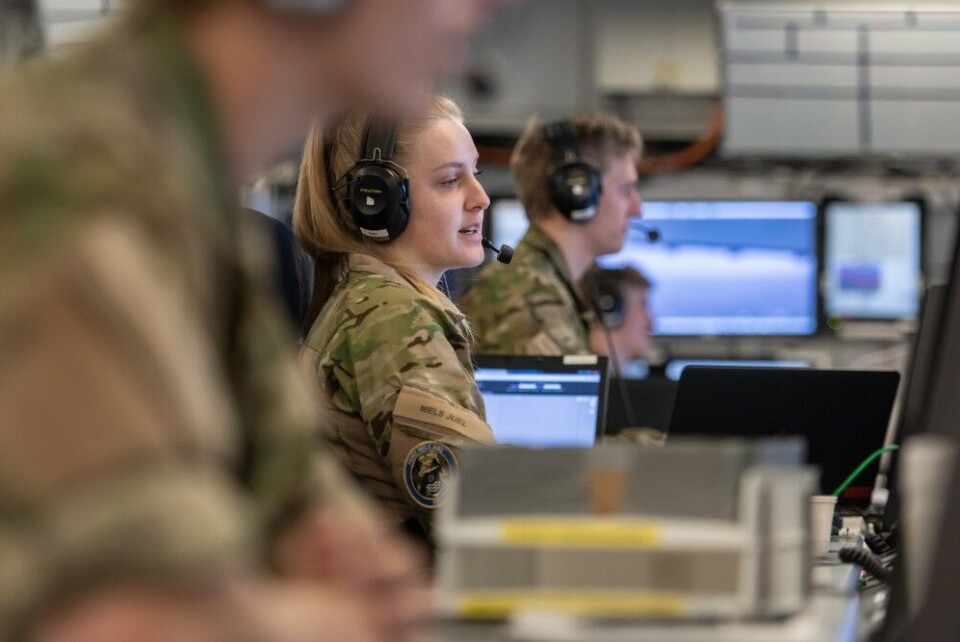 A Danish Navy Radar operator reports ships position while SNMG1 flagship Niels Juel, sails outbound Norwegian fjords as Exercise Dynamic Mongoose kicks off. NATO Photo by FRA N WO Christian Valverde
