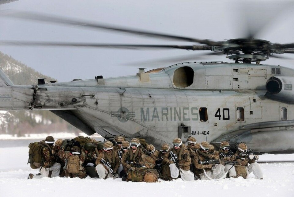 Dutch navy infantrymen sitting in perimeter on the ground when two US CH- 53E Super Stallion helicopters taking off during winter exercise Cold Response 2016. Photo: Thorbjørn Kjosvold, Forsvaret