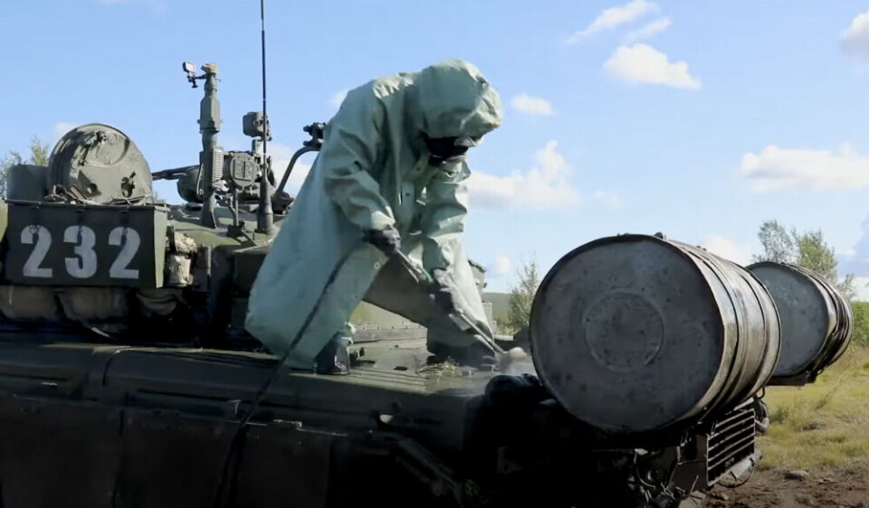 A soldier from the Northern Fleet's NBC Protection troop works on decontamination of a T-80 main battle tank. Photo: Northern Fleet