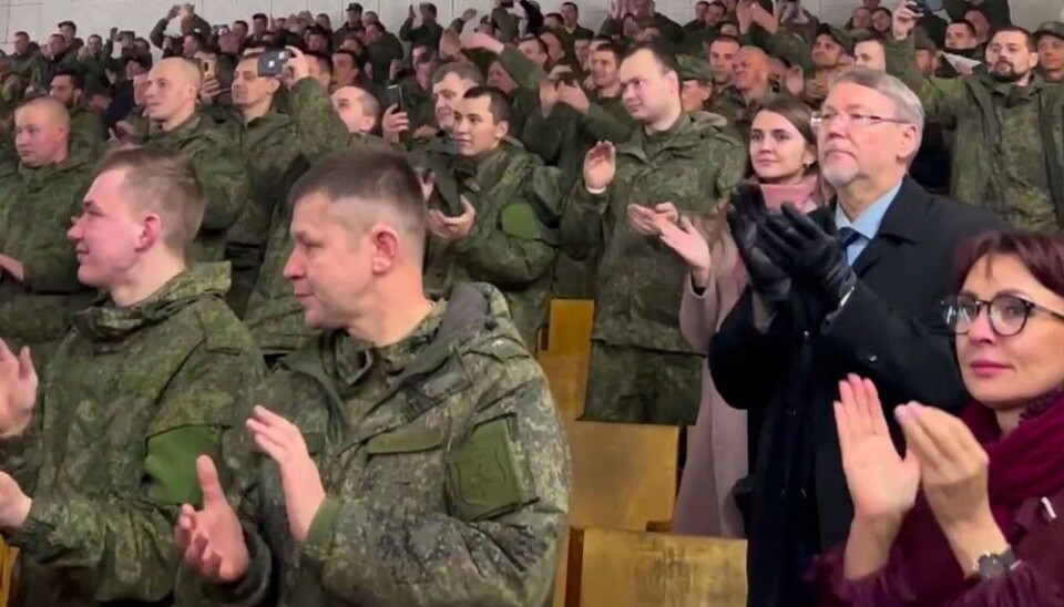 Mobilised men clapping to nationalist songs performed in Zapolyarny, the border town to Norway. Screenshot of video