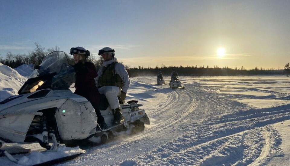 Anniken Huitfeldt in front of a snowmobile patrol next to the Russian border. Photo: Thomas Nilsen