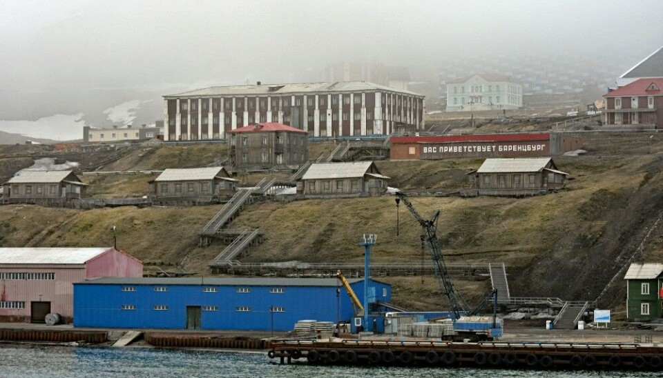 “Barentsburg welcomes you” reads the big sign in the hillside above the port. Photo: Thomas Nilsen