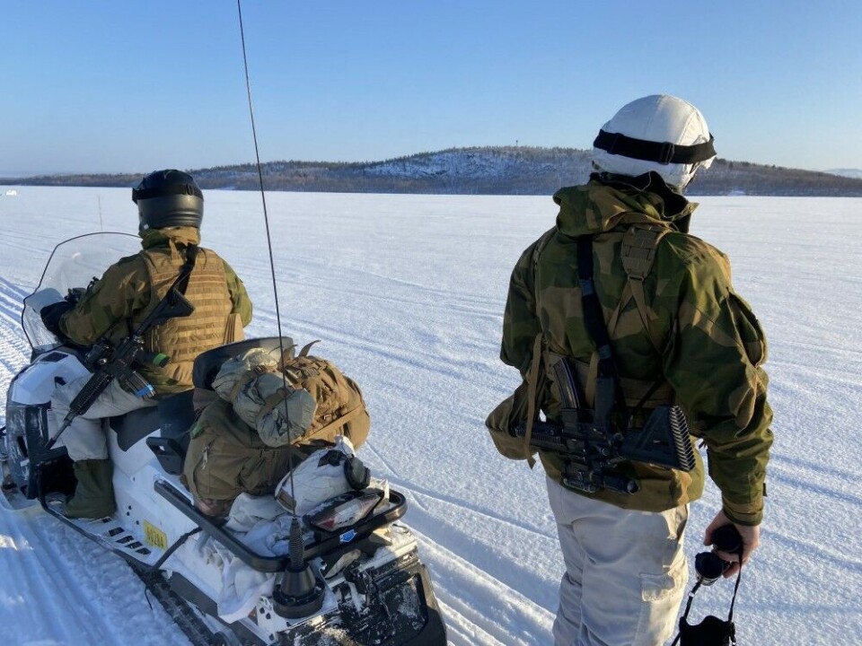 The soldiers on the Pasvik river in Norway's northeast corner will be the first to confront potential invasion forces from the heavily militarised Pechenga region. A Russian border guard tower can be seen on the top of the hill across the frozen river. Photo: Thomas Nilsen