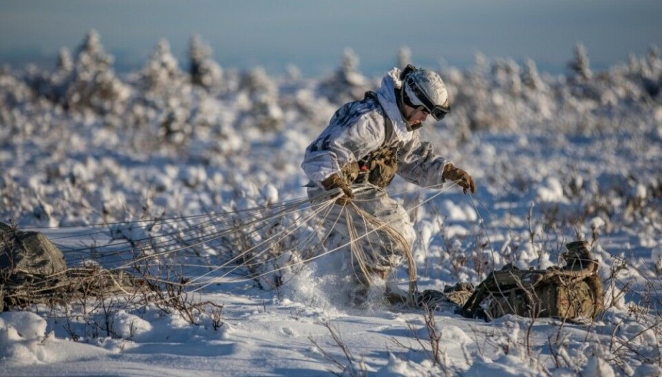 A soldier with the 11th Airborne Division packs up his parachute after an airborne operation. U.S. Army soldiers with this division now makes ready for a cross-Arctic flight. Photo: U.S. Army / Spc. Abreanna Goodrich