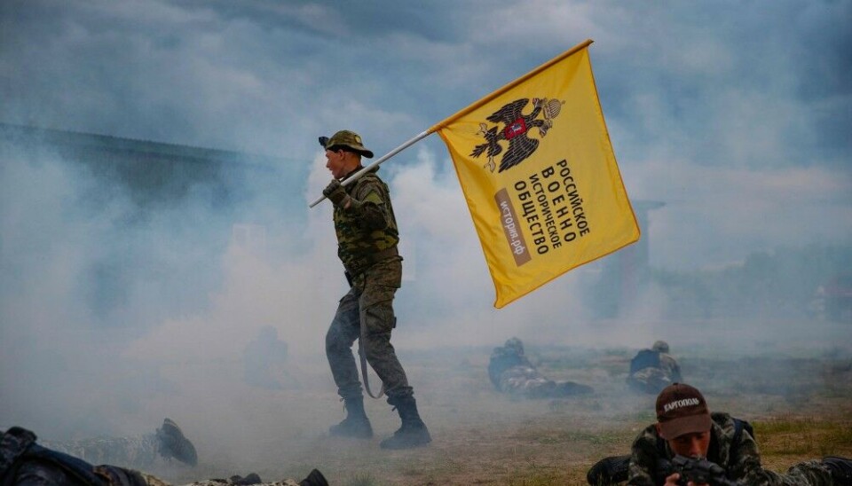 The flag of the Russian Military-Historical Society waves in a show-off exercise with kids in Arkhangelsk region. Photo: Arkhangel Center for Development of Children on VK