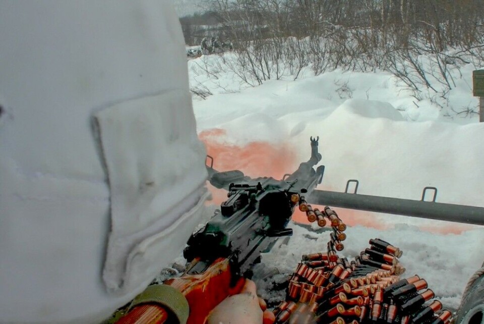 One soldier shoots with a belt-fed heavy machine from the roof just over the Red Cross. Photo: Northern Fleet press service