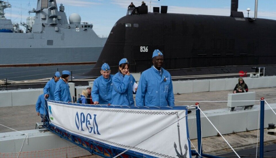 Dressed up in blue, this group of military attachés embarked the Oscar-II class nuclear powered cruise missile submarine 'Orel.' On the other side of the pier is Russia's newest Yasen-M class multi-purpose submarine 'Krasnoyarsk'. Photo: Information office of the Northern Fleet