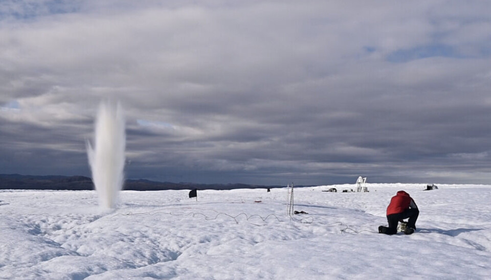 Alun Hubbard sends a pulse of energy through the glacier during one of the seismic experiments near camp. Photo: Henry Patton