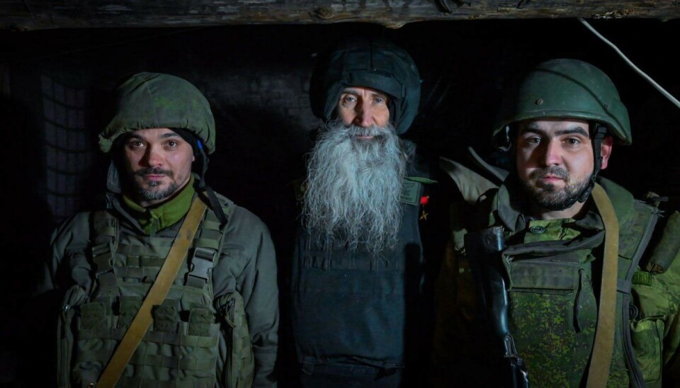 With a cross and a gun. Russian church at war