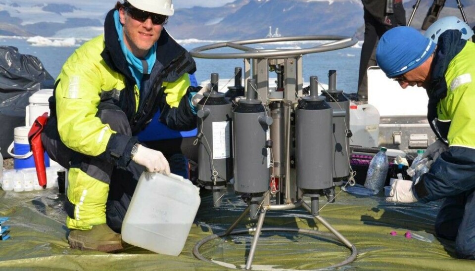 Water sampling at an improvised beach camp near the Kronebreen glacier front in Kongsfjorden.