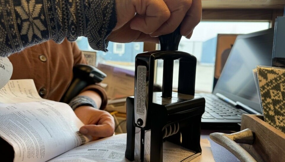 Lyudmila Wille stamping the receipts from the Russian customers. Photo: Elizaveta Vereykina