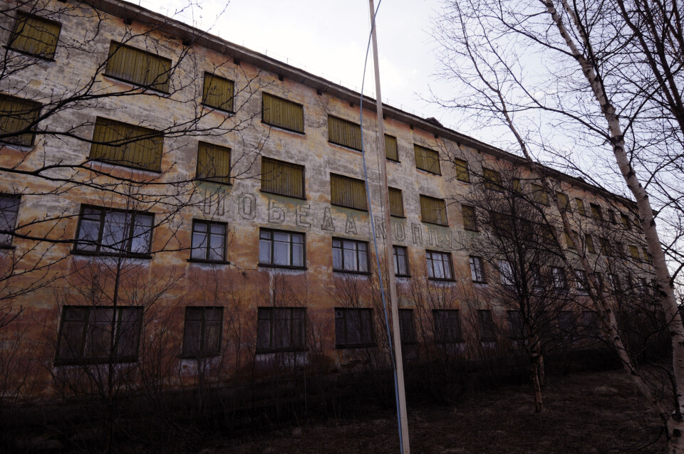 “The Victory of Communism is Inevitable” reads the slogan on the wall where Soviet air force officers once were living.Photo: Thomas Nilsen