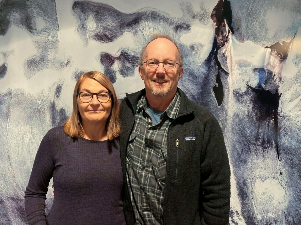 Glaciologists Elisabeth Isaksson and Jack Kohler met each other on a glacier in Sweden when they were young. Since then, they have married, had two children, moved to Tromsø and conducted scientific fieldwork on both Arctic and Antarctic glaciers. The wall behind them shows a portrait of one of Svalbard’s many glaciers. Photo: Elin Vinje Jenssen / Norwegian Polar Institute