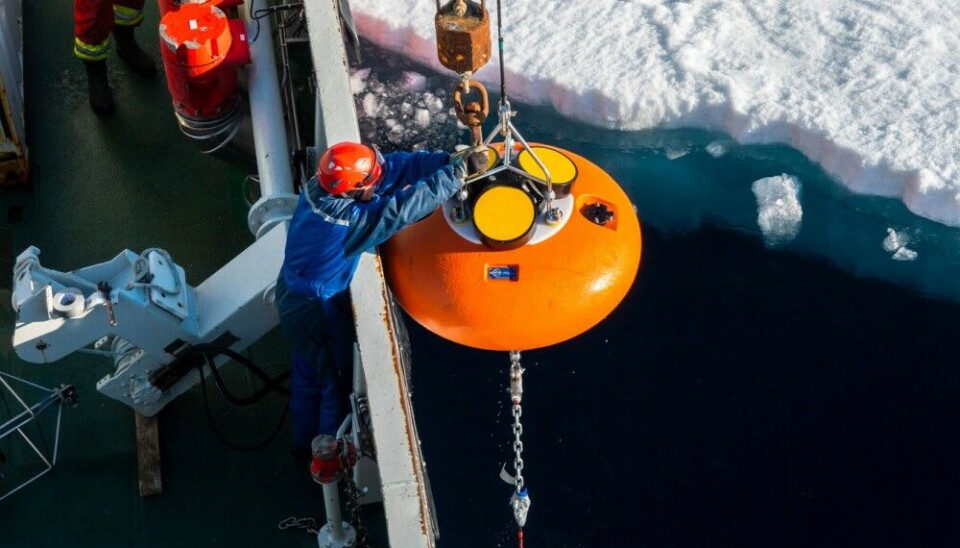 Deployment of the Norwegian Polar Institute’s deepest (4200 m) and northernmost (86° 32’ N) mooring “Amundsen-1” from the research vessel Kronprins Haakon though a small lead in the sea ice on 7 August 2022. Senior engineer Kristen Fossan (Norwegian Polar Institute) is releasing one of two acoustic Doppler current profilers that will provide year-round current measurements in the upper 500 m. The whole operation took around three hours to complete and required good coordination with the captain controlling the ship and crew operating a crane and a mooring winch. Recovery is planned for summer 2024. Photo: Trine Lise Sviggum Helgerud / Norwegian Polar Institute