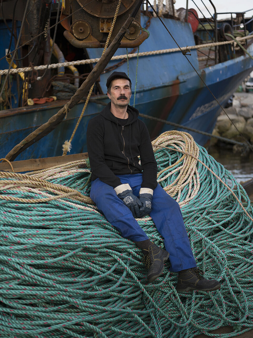 Sergey, Russian crab fisherman in front of his trawler moored at the port of Kirkenes, Norway. Photo: Céline Clanet