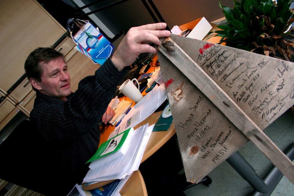 A radioactivity warning sign from Novaya Zemlya shares Salve Dahle’s office space. The back of the sign bears the signatures of participants in the 1992 cruise to the Pechora Sea and Novaya Zemlya. Photo: Nordlys