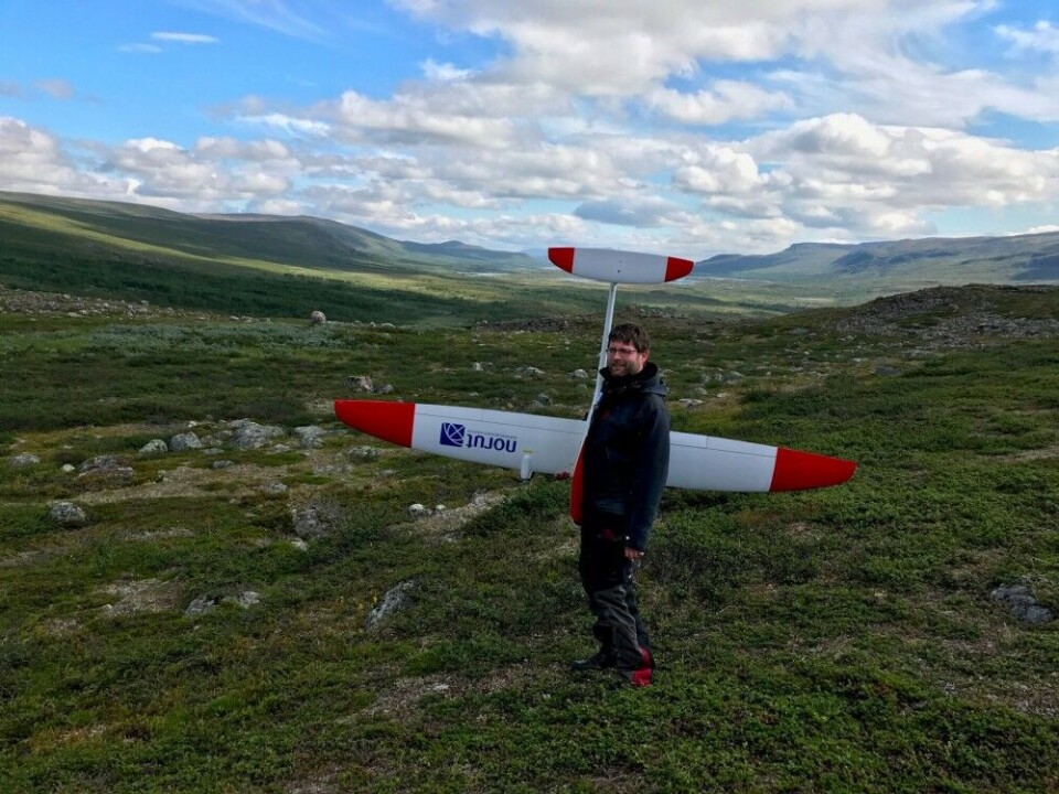 Researcher and drone enthusiast Stian Solbø from Norut participated in the drone mission. He is carrying the CryoWing Scout they used to experiment with factors such as flight altitude and camera settings. Photo: Tore Riise / Norut