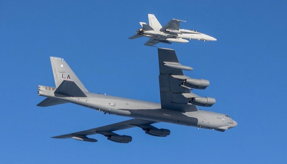 The U.S. Air Force B-52 bomber (60-0008) flying wing-by-wing with a Finnish F/A-18 Hornet.