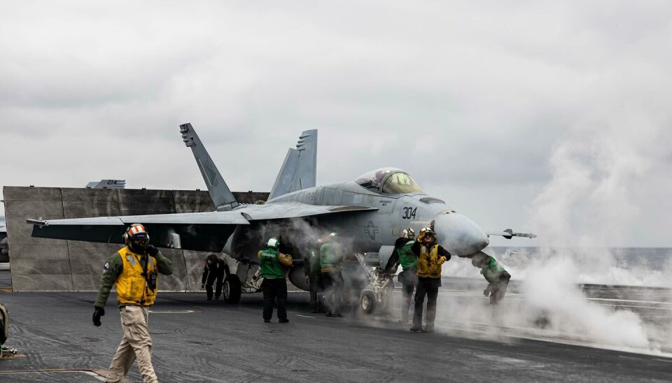 One of the F/A-18 Hornet makes ready for take-off from the flight deck of the carrier outside the coast of Norway.