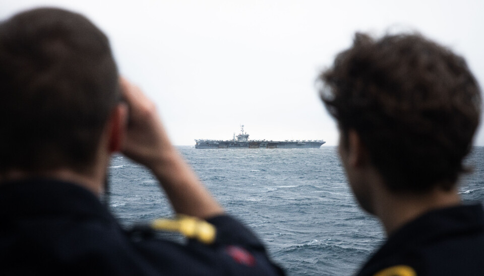 Crew members on Norway's frigate KNM Roald Amundsen looking at the American aircraft carrier USS Harry S. Truman. Other NATO warships in the area includes KNM Thor Heyerdal, logistic vessel USNS Artic, the Italian frigate Carabiniere and the Danish frigate HDMS Vædderen.