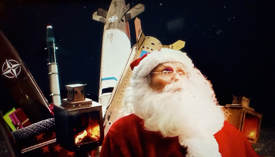 The animated video shows the Westerns Santa in his reindeer-lead sleight carrying NATO missiles in the sky above the Bolshoi teather in Moscow.