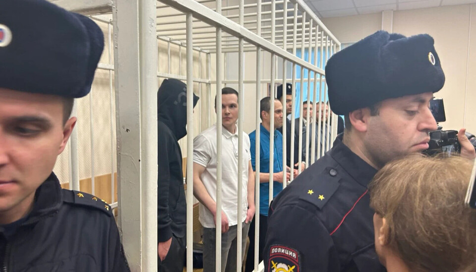 Igor Sergunin, Aleksei Lipster and Vadim Kobzev behind bars in the courtroom