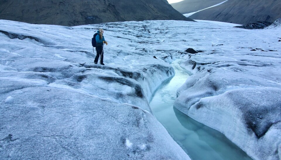 Dr Gabrielle Kleber assesses the meltwater streams on the surface of the Vallåkrabreen glacier on Svalbard