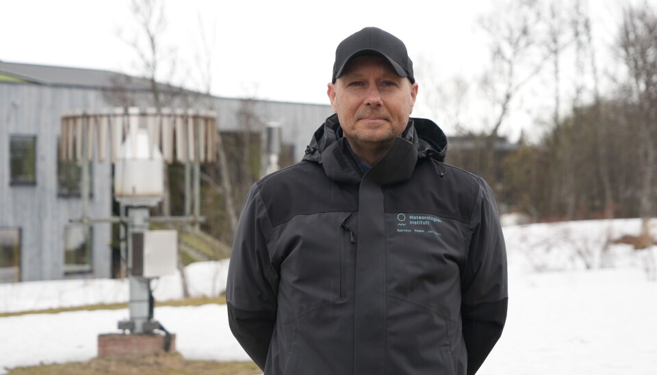 Thomas Olsen from MET with percipitation measuring devices in the background