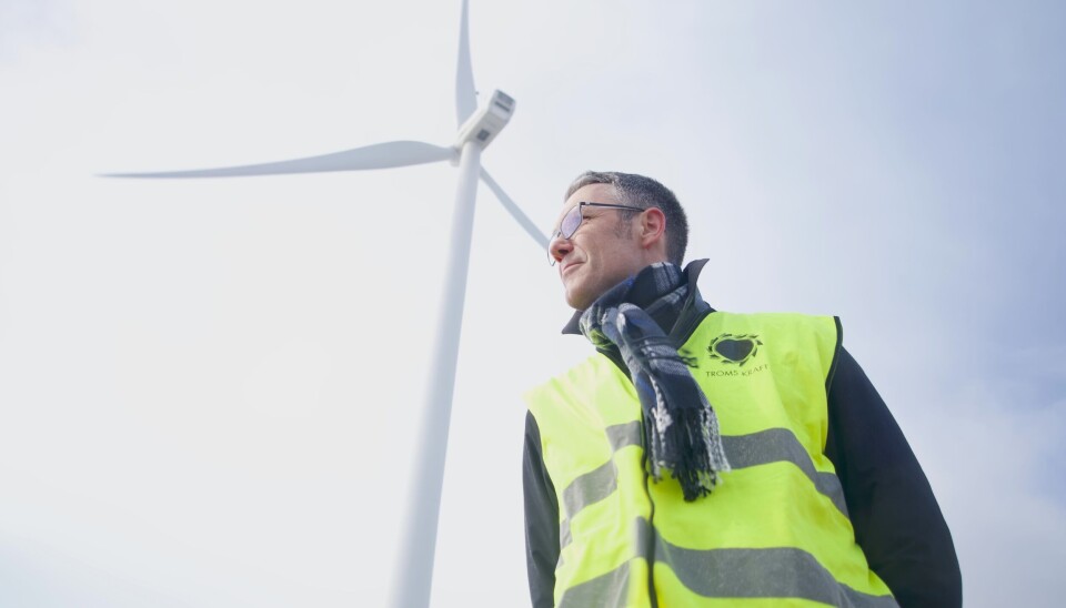 Geir Håvard Hanssen, head of renewable development at Troms Kraft, stands under a wind turbine of the Fakken wind park.