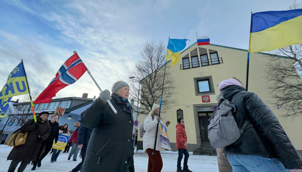 People in Kirkenes rally in support of Ukraine in front of the local Russian general consulate building.