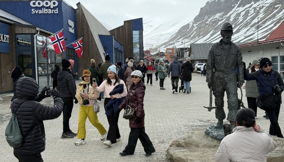 Cruise ship passengers enjoy a walk in the world's northernmost town, Longyearbyen. On Saturday, the visitors outnumbered the local residents in the centre.