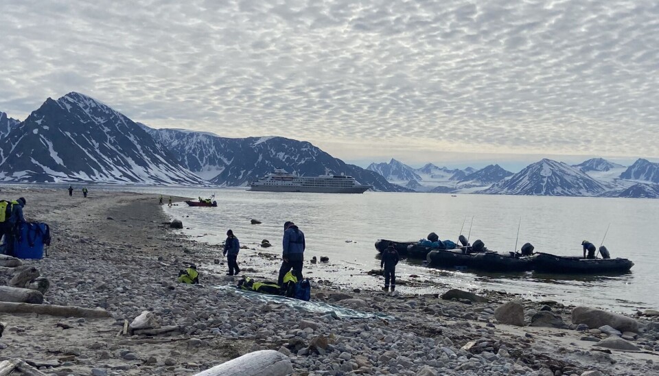 Expedition cruise ship makes landing with zodiacs at the Amsterdam island far north on Svalbard.